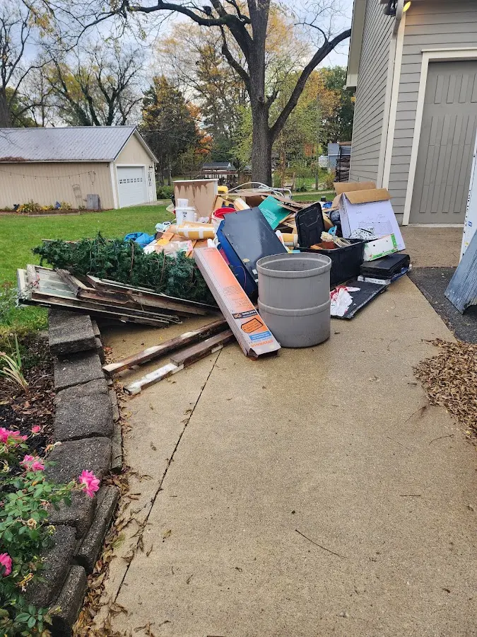 Dumpster being loaded with debris for Demolition Dumpster Rental in Louisburg
